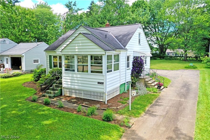 Masterfully kept and appealing from the inside out with its park-like presentation, this wonderful Champion 3 possibly 4-bedroom Cape Cod is tucked behind the shady veil of tall trees and lush landscaping, this delightful residence is quick to charm with its forward sunroom, mulch lined sidewalk and multiple entrance ways. Conveniently located on quiet street and Champion Schools. The cement driveway includes a turn-around before finding a large two car garage and nearby patio space. Inside, a carpeted living room awaits with cozy views and plenty of soft, natural lighting. A sculpted archway leads to the main hall, spilling into the kitchen where eat-in dining space joins the handsome wood cabinetry. A pair of lovely first floor bedrooms boast hardwood flooring and ample closets as they surround a brightly lit full bath. Upstairs, additional hidden walk in storage is located next to the staircase. Meanwhile, the spacious landing opens into the third, loft bedroom. Hardwood flooring throughout even under the carpet. Partially finished basement level with bar and additional recreation space along with laundry, spacious storage, workshop and ½ bath.