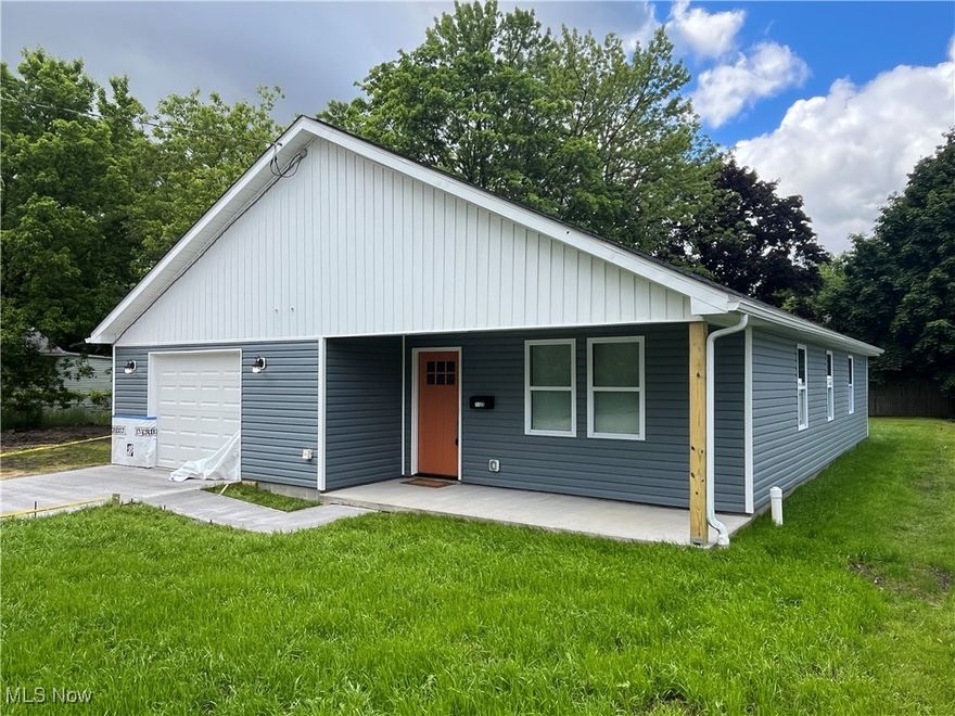 Are you in search of brand-new home not located within a development? Look no further than 1122 Delos St in Akron! This ranch-style home boasts 3 bedrooms, 2 full baths, and 1,364 square feet of living space. Meticulously designed with all the extra details you would choose if you built it yourself, this home features LVP flooring throughout the open-concept main living area and a gourmet kitchen with a breakfast bar, quartz countertops, brand-new cabinetry, and appliances. The pendant lights and blue vertical backsplash provide a unique, eye-catching aesthetic that will impress all who enter. Laundry is conveniently situated off the spacious dining area. The primary ensuite includes a large walk-in closet and a generously sized primary bath with a modern vanity and plenty of space. Two additional well sized bedrooms and full bath give you plenty of room for comfortable, single-floor living. The oversized garage provides extra storage space, a side entry door, and additional storage above—perfect for a slab home. With a tankless hot water heater and all-new mechanicals, everything is ready for you to move in. This property also includes a one-year builder warranty and is eligible for a 15-year tax abatement per the City of Akron!