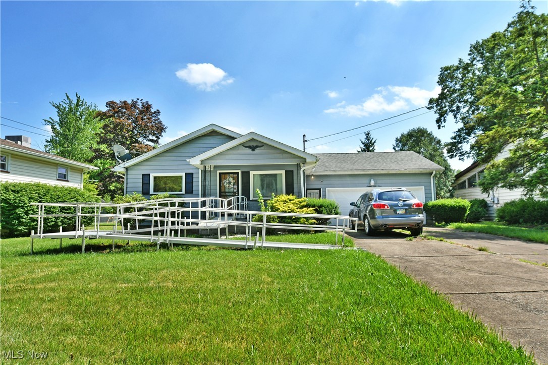 Potential packed and waiting for you, this darling Warren residence has plenty to offer! Located in a quiet neighborhood, this home quickly stands out with its winding aluminum mobility ramp for easy access if desired. Its charming blue exterior colors bring a hint of excitement as the cement driveway runs up to find an attached two car garage. Around the back, a raised rear deck overlooks the sizeable backyard. Step inside to be met with a welcoming living room, lined in tall windows that spill natural light across the carpeted flooring. The kitchen and dining areas are partitioned off by a jutting cabinet that marks the basement and garage entryways. The kitchen itself hosts a bevy of wood-faced cabinets and display cases as eat-in casual dining looks on. A tiled backsplash joins the stone-look countertops for added flair. Meanwhile, an impressively sized guest bedroom is just steps away with its large closets and instant deck access. Down the main hall, a pair of equally substantial bedrooms are painted in bright colorways as they surround a deep-set full bath with its floor entry shower. Finished rec space and a bonus room can be found at the basement level along with an additional full bath and utility access. Roof, A/C, Furnace,n HWT and Windows are all less than 6 yrs old. The ramp was installed by VA, removal is possible but not guaranteed.