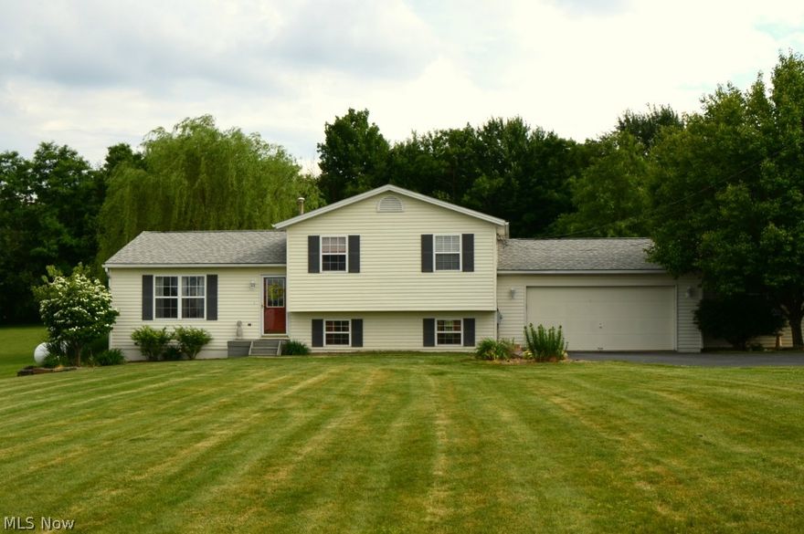 New Waterford's hidden beauty. All the home you need inside, with a taste of paradise outside. Beautifully landscaped & decorated describe this 3 BR, 2 bath home situated on nearly/acre of wooded tranquility that captures you inside and out. Spectacular 10'x29' kitchen, added in '09, includes Kraftmaid cabinets w/slow close drawers, backsplash is subway tile w/glass mosaic and 18" porcelain floor tile. Counters are Santa Cecilia granite. Look out or relax on the 22x25 hand painted cement patio or enjoy the above ground pool. Surrounded by a 16x16 deck. All in the privacy of your own back wooded yard. This beauty is great for entertaining or to create family memories of a lifetime. The 2 car attached garage gives you plenty of room..but if you need more..there is a 12x18 attached shed. Don't miss out..Call today for your private showing.