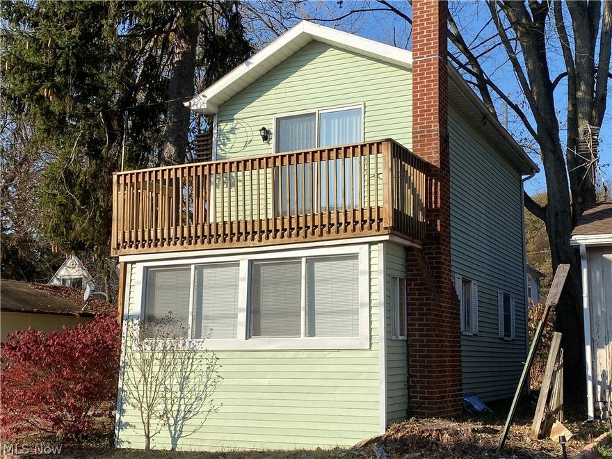 Easy to view through the holidays! Affordable opportunity to live in Portage Lakes!  Great dead-end locale of well-kept surrounding homes with lake privileges.  Public/city sewer with it's own private well.  Two (2) tandem bedrooms with nice closets, cathedral-type ceilings with slider to upper 16 x 8 deck for relaxing seasonable views.  Four (4) off road parking spaces. Appliances include refrigerator, stove/oven, dishwasher, two window air conditioners, washer and dryer.  Enclosed front porch 7x11 was used as a third bedroom in the past. Enclosed 9' x 6.5' back porch makes a handy kitchen pantry or fishing pole storage.  Lower deck 7 x 11 for grilling out.  Gas and electric heat, new bathtub and surround,  100 amp electrical box.  Seller providing one year America's Preferred Home Warranty for extra peace of mind.  Laundry, bath, and 7 x 11 bonus room in basement.  Near shopping, entertainment, dining, boating, and golfing.