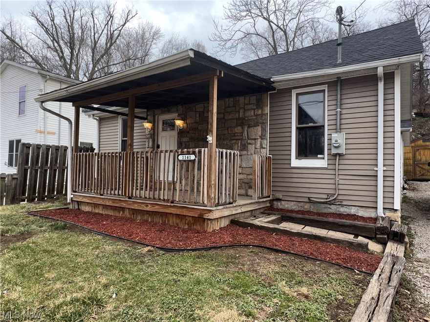 This spacious 2-bedroom 1 bath home has been beautifully refinished with you in mind. New flooring, roof, paint, cabinets and fixtures throughout. Additional parking or yard space on hilltop behind home.