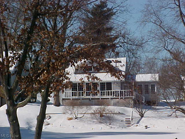 Enjoy the year round living on this lakefront property. Newer 80' sea wall with 3 hooks ups and electric. Lovely Cape Cod home with a first floor master. Wonderful view of the water from the newer kitchen, dining area, sun room and deck. Gas log fireplace in Living Room with a bonus room that could be office, more dining area or sitting area. Sun Room with cathedral ceiling, lots of windows and a hot tub. Both baths have been updated. Many major updates throughout the home, windows, electric, air, furnace, gutters and down spouts, whole house fan and roof. Storage barn-property is on 6 lots.