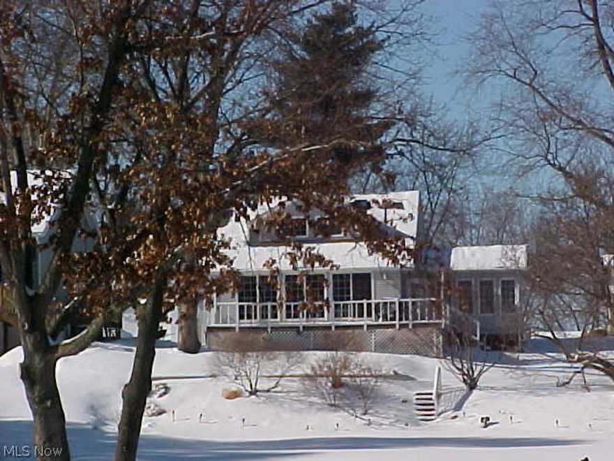 Enjoy the year round living on this lakefront property. Newer 80' sea wall with 3 hooks ups and electric. Lovely Cape Cod home with a first floor master. Wonderful view of the water from the newer kitchen, dining area, sun room and deck. Gas log fireplace in Living Room with a bonus room that could be office, more dining area or sitting area. Sun Room with cathedral ceiling, lots of windows and a hot tub. Both baths have been updated.  Many major updates throughout the home, windows, electric, air, furnace, gutters and down spouts, whole house fan and roof. Storage barn-property is on 6 lots.