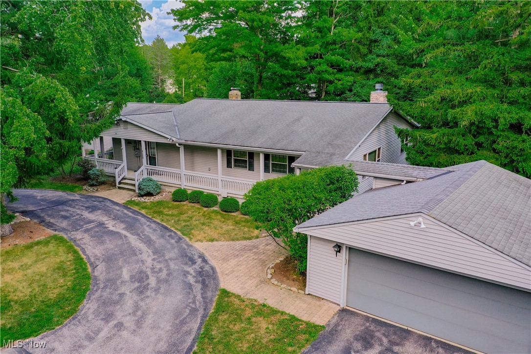 Welcome to this exciting four bedroom ranch home with three and a half bathrooms and huge living spaces in beautiful Kirtland! With over 3100 sq ft on the main level and finished full basement, there is plenty of room! The additional 4 bay garage/outbuilding is incredible for the self employed, ideal for housing equipment any trade business, for landscaping equipment, home remodeling or even a car collection! Plenty of additional upstairs space can be finished out as an additional living suite. In the home, the charming front porch opens to the impressive light filled great room with wall to wall carpeting and gas log fireplace with stone accents. French doors open to the cozy family room with a second gas log fireplace and adjoins the well equipped kitchen with newer appliances, granite counters and an abundance of cabinetry. The spacious primary suite, with large sitting area, has two walk-in closets and private bath. Two additional bedrooms share a hall bath, a guest suite has a second hall bath and all bedrooms have ceiling fans and generous closet space. The full basement is ideal for running a home business with its own exterior entrance, multiple office cubicles, a half bathroom and plenty of storage areas. The outbuilding measures 60x48 and has easily accessible second story space. It is insulated, has new exterior paint and siding (2024), includes heat and AC, a half bathroom. The sprawling yard is perfect for outside entertaining and a wonderful water feature provides for peaceful sounds in the summer. This home was owned for 38 years by a master electrician who added every possible electrical safety measure throughout home and outbuilding! This one of a kind home is ready for new owners to take advantage of all this property has to offer!