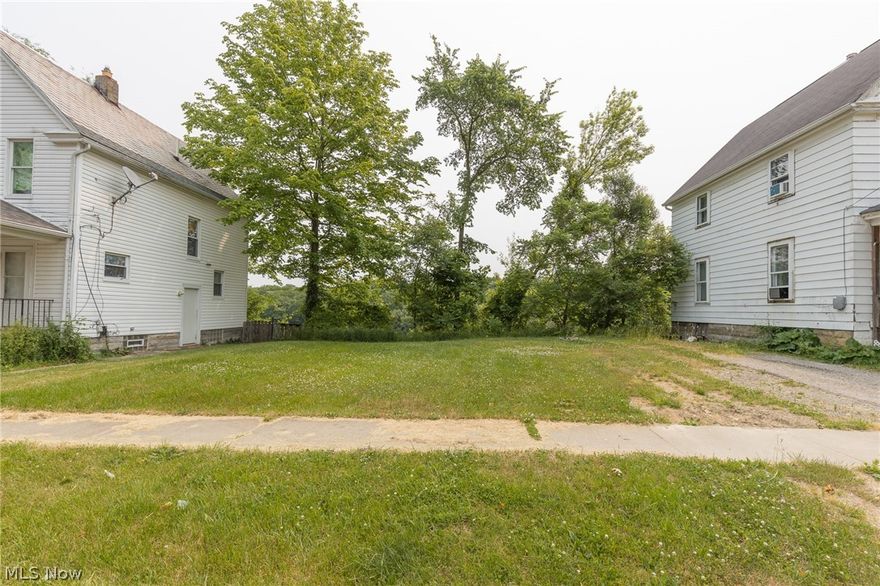 Beautiful flat lot with mature trees in the back. Close to downtown Elyria and the recently renovated Cascade Park. The back part of the lot overlooks the park.