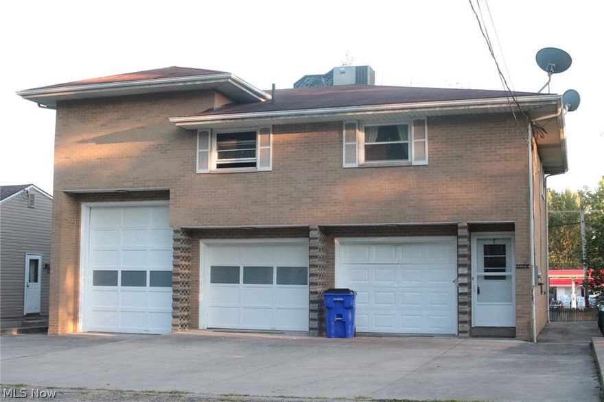 Amazing Ravenna home!  Perfect for RV lovers! The most intriguing feature of this home is the incredibly spacious garage.  It has a port big enough to fit an RV, large truck or even a boat!  There is a workroom framed and waiting to be finished.  A 220 hook up for electric is installed in the garage, along with heat. There is also a large half bath, storage room and walk out to the back patio from the garage.  Up to the main living area.  The kitchen offers new tile flooring, brand new cabinets, counter tops, and lighting.  The open floor plan flows right into the living room area.  There are sliding glass doors that allows for lots of sunlight to and a lovely view.   The balcony is a nice bonus, overlooking the large back yard. Spacious master bedroom has two large closets, plus built-ins!  The full bathroom has all new tile tub surround, new vanity, new tile flooring and endless storage.  Up just a few steps to the next level, featuring two very sizable bedrooms along with a fourth b