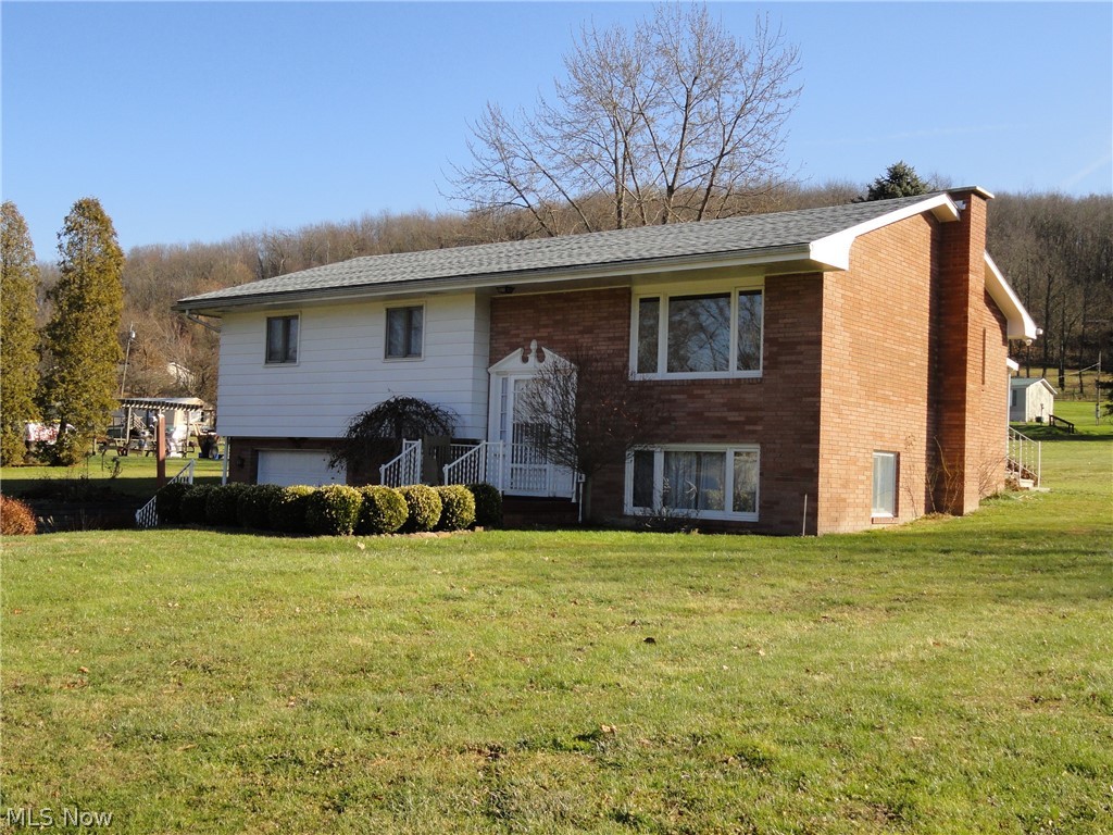 Very well maintained 3 BR/1 Bath Bi-Level home features LR, Kitchen/DR combo that opens to a large covered back patio, large Laundry/utility room, craft room, & spacious Family room situated on a nearly 1 acre lot. Single car integral garage + 2 car detached. Conveniently located close to Racetrack/Casino, Cracker Plant, State Park, PA/OH borders & approx 25 mins. to the Pittsburgh airport. Low WV property tax.
