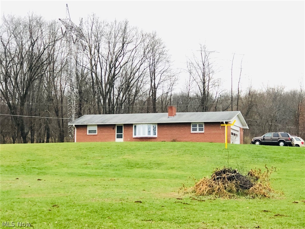 What a view! Brick ranch on 7.418 acres offers 2 bedrooms, 1 bath, oak kitchen cabinets with breakfast bar and a nice sun room off eating area. Enjoy a cozy evening in front of the wood burning fireplace in the living room. Newer 90+ furnace, replacement windows through out and updated bath. Need more space? The full basement is ready to finish with a 2nd bath plumbing already started. 24x48 barn is perfect for so many things. Road frontage on both Schenck Creek and Monroe Mills. Just needs some fresh paint and new flooring to make her SHINE!