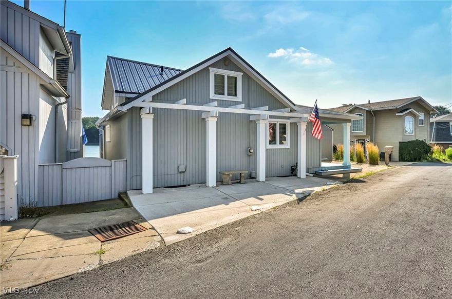 Your lake life starts here! This gorgeous lakefront ranch on West Reservoir, part of the Main Chain of Portage Lakes, offers 58 feet of prime waterfront, a private dock, and rare parking for up to seven cars. Designed for comfort and low-maintenance living, this home blends modern updates, thoughtful design, and year-round lake enjoyment. Step outside and experience triple-tier lakefront entertaining - a true standout feature. Enjoy a custom covered TV lounge off the master suite, a circular sitting area, a grilling and dining zone, and deck seating right at the water's edge. White modern railings, in-deck solar lighting, and a retractable ShadeFX canopy create an upscale, serene setting perfect for both daytime relaxation and evening sunsets. Inside, the bright living room showcases stunning lake views, a gas fireplace, and new sliding glass doors leading to the deck. The kitchen features a dimensional skylight, recessed lighting, and stainless steel appliances. The waterfront master suite offers private deck access, a large walk-in closet, custom crown molding, and a full ensuite bath. The lower level includes a second full bath, semi-finished flex space ideal for a rec room or guest area, laundry, storage, and under-deck storage for kayaks and canoes. Major upgrades include a new metal roof, 2024 furnace, new carpet, on-demand water softener, extended cement drive, custom 10'x12' shed, solar dock lights, and a newly added swimming cove. Whether you're searching for a full-time lake home, weekend retreat, or investment rental opportunity, this property delivers luxury, functionality, and the Portage Lakes lifestyle all in one package. Point of Sale, septic, and radon inspections are complete and passed - move-in ready.