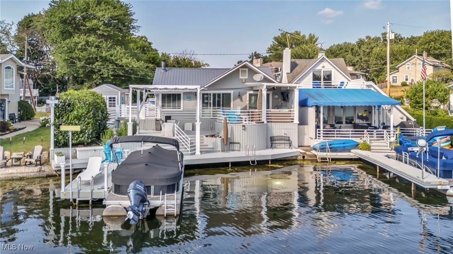 Your lake life starts here! This gorgeous lakefront ranch on West Reservoir, part of the Main Chain of Portage Lakes, offers 58 feet of prime waterfront, a private dock, and rare parking for up to seven cars. Designed for comfort and low-maintenance living, this home blends modern updates, thoughtful design, and year-round lake enjoyment. Step outside and experience triple-tier lakefront entertaining - a true standout feature. Enjoy a custom covered TV lounge off the master suite, a circular sitting area, a grilling and dining zone, and deck seating right at the water's edge. White modern railings, in-deck solar lighting, and a retractable ShadeFX canopy create an upscale, serene setting perfect for both daytime relaxation and evening sunsets. Inside, the bright living room showcases stunning lake views, a gas fireplace, and new sliding glass doors leading to the deck. The kitchen features a dimensional skylight, recessed lighting, and stainless steel appliances. The waterfront master suite offers private deck access, a large walk-in closet, custom crown molding, and a full ensuite bath. The lower level includes a second full bath, semi-finished flex space ideal for a rec room or guest area, laundry, storage, and under-deck storage for kayaks and canoes. Major upgrades include a new metal roof, 2024 furnace, new carpet, on-demand water softener, extended cement drive, custom 10'x12' shed, solar dock lights, and a newly added swimming cove. Whether you're searching for a full-time lake home, weekend retreat, or investment rental opportunity, this property delivers luxury, functionality, and the Portage Lakes lifestyle all in one package. Point of Sale, septic, and radon inspections are complete and passed - move-in ready.