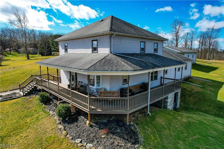 Enjoy all the benefits that come with a Country setting.  Situated on just over 8 acres, this 4 car garage, 4 bedroom, 2 Full bath Charmer is a MUST see!  You won’t miss the gorgeous hardwood flooring throughout the massive living room with access to the endless wrap around porch where you can enjoy countless mornings and evenings.  The charming bay windows offer plenty of natural lighting perfect for enjoying the scenic view or reading a book.  Entertaining won’t be hard with this gigantic open concept eat-in kitchen and breakfast nook featuring updated kitchen cabinets. Cooking will be fun in this lovely country kitchen which offers plenty of counter space and storage, including an island.  You will notice the beautiful recently remodeled bathroom featuring a soaker tub and shower.  The large mud room and main level laundry is definitely a bonus.  With plenty of garage space, the massive detached garage is perfect for storing all your toys.  Don’t miss your opportunity, call an agent today and schedule a showing.