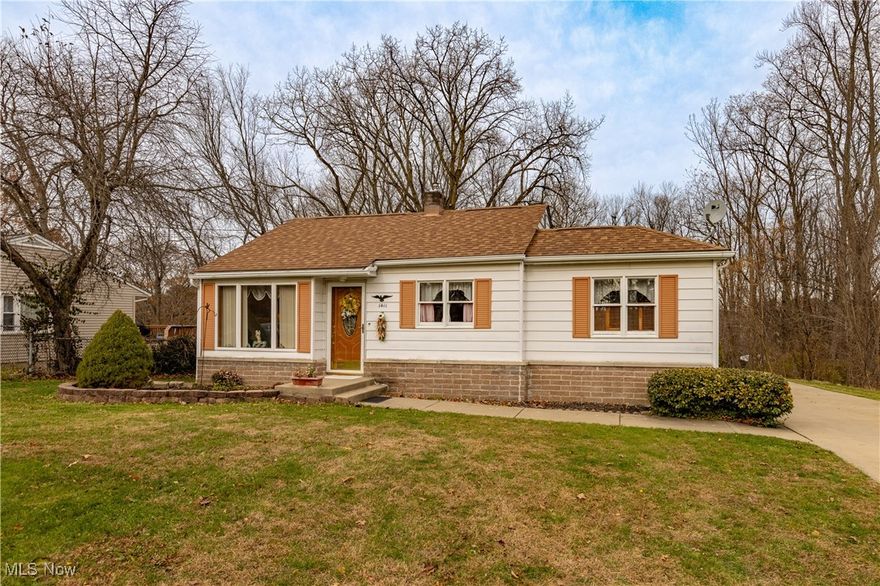 Welcome to 1411 Chapman Drive! This charming Ranch-style home in Akron offers 1,159 square feet with three bedrooms and one full bathroom. The bright Living Room leads directly into the Kitchen, which features ceramic tile flooring, counters with a breakfast bar, a ceramic tile backsplash, a suite of Maytag gas cooking appliances, and a nearly brand new Frigidaire LG refrigerator. The adjacent Dining Room provides easy access via a glass slider to the side wood deck and back garden. This home includes a spacious walk-out, full, unfinished basement with laundry facilities and rough-in plumbing, offering excellent potential for expansion. With a concrete double-wide driveway, this classic ranch is ready for its next owner. Enjoy peace of mind with a 1 yr home warranty included by the seller, offering extra protection for your major systems and appliances.