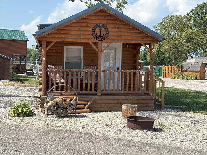 Wow, your own Retreat so close to the shores of Lake Erie.  This charming cabin is easy to maintain and will provide the relaxation you crave.  Enjoy the covered front porch or take advantage of those peaceful nights around your fire pit.
When you are ready for action this area offers an abundance of activities from the Strip at Geneva-on-The-Lake, to the scenic Lake Erie Coastal Trail.  Zip lining at the Geneva State Park, or tour the many Grand River Wineries. Plenty of shopping and restaurants located on historic Bridge Street in the Ashtabula Harbor. Fishing, bicycling, kayaking and hunting are all activities available nearby.  This ranch style cabin has an open floor plan with exposed beams and tons of charm.  Use as a vacation home or as an Airbnb.  If interested in using as an Airbnb rest assured current sellers already have an established client base.  Now is the time to come and take a look and make this cabin yours!