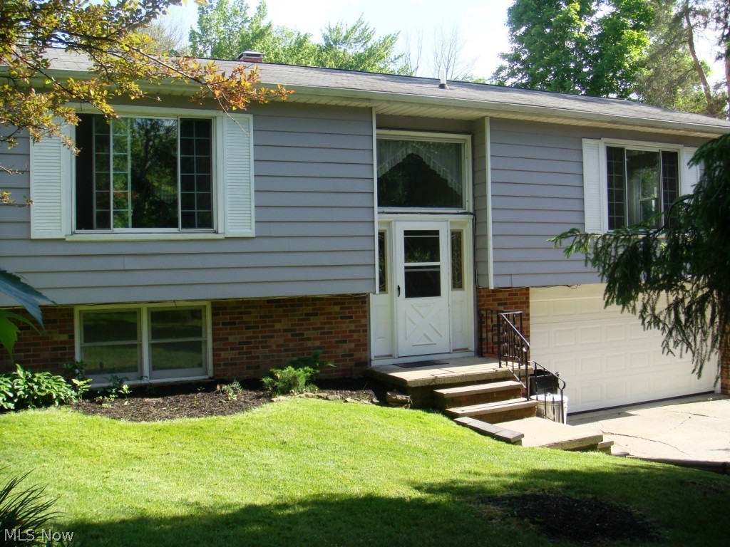 Beautiful 3-bed; 1.5 bath home nestled on more than a half acre of property! Entire home has been freshly painted and new carpet and flooring installed throughout! Main level boasts a spacious; open living area and large eat-in kitchen. Stunning picture window showers the living area in beautiful natural light. Sliding glass doors lead out from kitchen to a lovely raised wood deck to enjoy gorgeous view of quiet; semi-private back yard! Main level also has a cozy master bedroom with convenient access to the recently updated full bathroom. Two additional nice-sized bedrooms also located on the main floor. Partially finished lower level provides approximately another 400 square feet of finished living space. Would make the perfect family/recreation room or a large fourth bedroom! Updated half bath and laundry/utility room also located in the lower level. Back yard is partially fenced and offers plenty of room for a garden and ample space for entertaining family and friends! Fresh, c