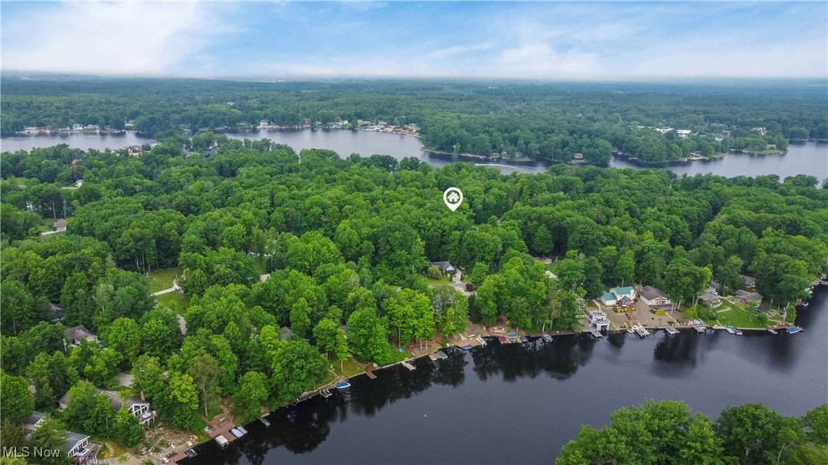 Are you still searching for your dream vacation home or lake house but haven’t found the right fit? If you haven’t acquired the perfect getaway to bring your loved ones together, maybe it’s time to create it! Welcome to this flat and level 0.22-acre vacant lot with 75 feet of frontage in Roaming Shores—just one block from the water! Being the most affluent community in Ashtabula County, hallmarks of this village include stable and rising property values, a high rate of owner-occupied homes (few rentals), and over 10 private clubs. Residents say their homes are popular destinations for family/friends, claiming if you live here—there’s no need to go on vacation! The community’s perks alone make owning a lot worthwhile—even if you don’t plan to build. Lake Roaming Rock is the largest private lake in Ohio. With 470 acres, a main channel depth of 35+ ft, a full-service marina/store, a three-lane paved boat ramp, coves, and nearly 30 miles of shoreline, the lake is ideal for boating/fishing. It features a healthy population of largemouth and smallmouth bass, crappie, silver and channel catfish, perch, and bluegill—all supported by an active stocking program run by the Fishing Club. This quiet, accessible lake is truly an angler’s dream! Community amenities include two beaches, four heated pools, a seven-mile water-skiing loop, parks, playgrounds, the Western Reserve Greenway Trail, volleyball, basketball, tennis and pickleball courts, baseball fields, a 3,500 sq. ft. clubhouse, over 20 outbuildings and picnic pavilions (with grills and a concession stand), and a compost site. Roaming Shores residents enjoy the safety of a full-time Police Department, the convenience of a nearby grocery store, and a year-round lakefront restaurant—Paradise Bay. Several public golf courses and campgrounds are within 20 minutes, and the central location offers tranquil living just one hour from Cleveland, Erie, and Youngstown. So stop searching and start building memories at Roaming Shores!