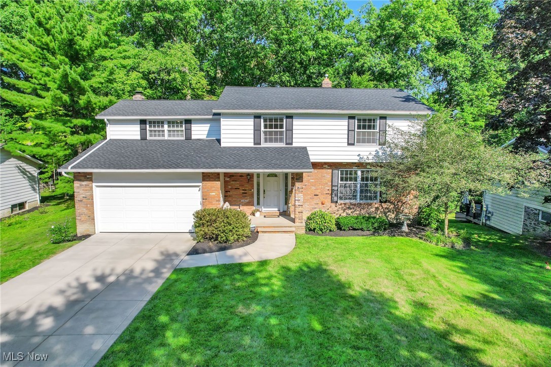 This updated colonial sits on a private wooded lot in a highly sought-after Solon neighborhood. Thoughtfully improved inside and out, the home blends classic design with modern comfort.
The first floor features refinished hardwood floors throughout, a main staircase with matching hardwood, fresh interior and exterior paint, crisp white trim, and newer carpet in select areas. The living and dining rooms are filled with natural light from Pella windows and enjoy scenic wooded views.
The renovated kitchen offers stainless steel appliances, a custom center island with bar seating, a large pantry, tiled backsplash, and an open floorplan connecting to the family room with its wall-to-wall brick fireplace. The main-level bathroom has also been renovated with updated finishes.
Sliding doors lead to a newer wood deck and paver patio—ideal for relaxing or entertaining—overlooking the backyard. Additional updates include a 2024 roof, newer driveway and walkway, freshly landscaped yard, and newer garage door.
Upstairs, the primary suite includes a remodeled bath with double sinks, a tiled shower, and a walk-in closet. Three additional bedrooms, including a large room over the garage, share another updated full bath. The finished lower level provides flexible living space, laundry, and storage, with a walk-out to the backyard.
Located near schools, parks, the recreation center, and shopping—this home is ready for its next owner to enjoy.