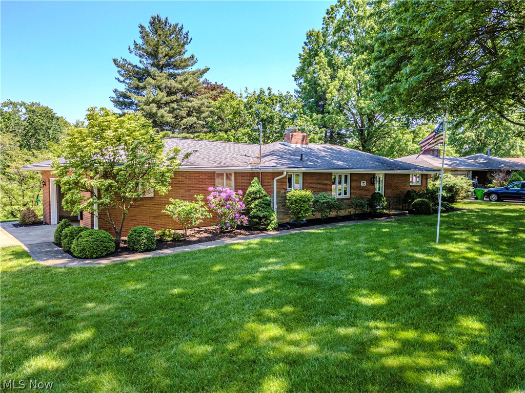Introducing a charming, one-owner home nestled in the perfect location and awesome neighborhood! Step inside to the expansive great room with a fireplace that is flooded with natural light from the huge windows that overlook the picturesque yard, with access to a lovely covered back porch, perfect for enjoying morning coffee or summer evenings. The heart of this home is a gourmet kitchen adorned with hickory cabinet doors, a gas cooktop, and elegant quartz countertops. Discover large bedrooms and an updated main floor bath featuring a luxurious walk-in shower. The lower level of this home features a finished recreation room with a cozy wood-burning fireplace, an office area, a full bath, and a dark room - ideal for the photography enthusiast. The lower level also offers a walkout to the backyard to a beautiful brick patio, barn stone, and a meticulous railroad tie staircase. This well-loved property boasts an immaculate yard with stunning landscaping! Impeccably maintained, the property features updated windows, roof, furnace and much more, offering peace of mind for years to come. This property is truly a haven for those seeking the perfect blend of comfort, style, and functionality. Whether you're looking for a serene retreat or an entertainer's paradise, this home has it all. Don't miss the opportunity to make this well-cared-for home your own. Schedule a showing today and get ready to fall in love with the charm and warmth of this exceptional property.