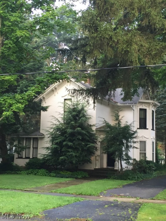 Very rare opportunity to own one of the most historic homes in Chagrin Falls. This is an original Church Family Home that is now being offered for sale for first time in over 100 years. Built in 1880 it retains its original woodwork, 12 foot ceilings, eight foot tiger maple doors throughout the home. Massive ornamental molding in each room with intricate details and some original lighting. This home is being sold in addition to 54 Church Street (next door and sold separately) which was also owned by the Church Family. What makes this an incredible opportunity is the land behind the home: 4.5 acres with sweeping180 degree views of the Chagrin River. This is absolutely the last tract of land of this size that will ever be available in the historic district of Chagrin Falls.