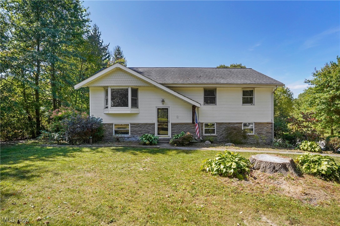 Welcome to this lovely home nestled on a 1.5 acre stunning lot in Auburn Township. Yes, there are some things that you may want to do to fix it up such as replace some carpet and paint, however, the kitchen and the bathroom are already updated! The bi-level has a spacious living room on the upper level that leads to the dining area, which then leads out to a vaulted sunroom which overlooks the most beautiful and peaceful back yard. Off the side of that vaulted sunroom, it leads to a deck, which then leads down to a patio with a pergola of wisteria and more! Back up to the dining area, it leads to the updated kitchen which is fully applianced. Rounding out the first floor you will find a beautiful bathroom with a modern sliding door with windows, and 3 bedrooms with mirrored closed doors. Down in the lower level will be the family room with a wood burning stove and a separate laundry room. The spacious 2 car garage enters this area. The home is situated off the road and is surrounded by lovely landscaping, ready for the next owners vision of enhancement. Kenston school district.