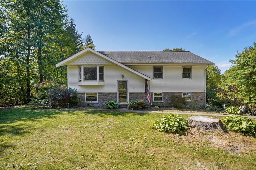 UPDATE: Motivated seller! Bring offers! Welcome to this lovely home nestled on a 1.5 acre stunning lot in Auburn Township. Yes, there are some things that you may want to do to fix it up such as replace some carpet and paint, however, the kitchen and the bathroom are already updated! The bi-level has a spacious living room on the upper level that leads to the dining area, which then leads out to a vaulted sunroom which overlooks the most beautiful and peaceful back yard. Off the side of that vaulted sunroom, it leads to a deck, which then leads down to a patio with a pergola of wisteria and more! Back up to the dining area, it leads to the updated kitchen which is fully applianced. Rounding out the first floor you will find a beautiful bathroom with a modern sliding door with windows, and 3 bedrooms with mirrored closed doors. Down in the lower level will be the family room with a wood burning stove and a separate laundry room. The spacious 2 car garage enters this area. The home is situated off the road and is surrounded by lovely landscaping, ready for the next owners vision of enhancement.  Kenston school district.