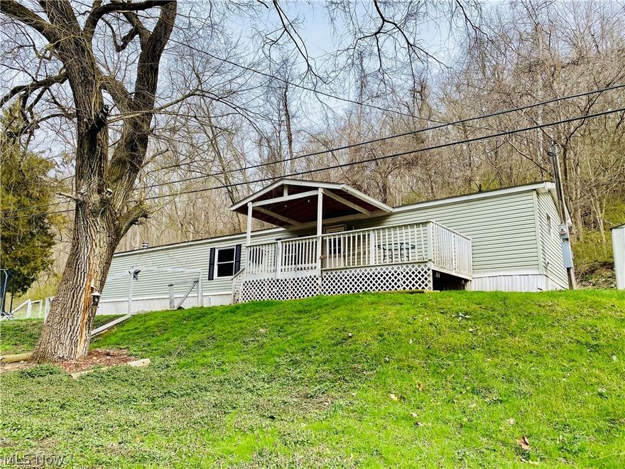 This updated 1995 Commodore mobile home sitting on nearly 8.5 acres provides lots of privacy in a country setting, yet it is located just a short drive to stores and restaurants.  The water heater was replaced one year ago, the electric furnace is just three years old, and the roof and windows are less than 10 years old.