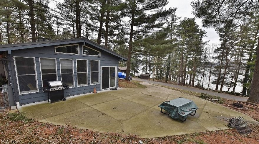 This is the one you have been waiting for! The perfect little lake cottage to getaway with stunning lake views. Situated in the peaceful North Shore community, this cottage has been meticulously cared for. Near the end of a dead end street, traffic is nearly non existent. The owners are making this a turn key opportunity by offering the home fully furnished & immediate possession at closing. A private quality dock is just across the street with easy access. To explore the lake included is a 2005 18' Sweetwater pontoon boat & 25HP 4 stroke motor. The cottage features an open format with vaulted beamed ceilings. You will cherish the incredible views from the living room with stone wood burning fireplace, dining area, kitchen & enclosed sun room. Large mechanical room for storage. The spacious sun room is perfect for enjoying this stunning setting & just outside is a concrete patio & fire pit. Fenced back yard is ready for the pets. A few of the many recent improvements include furnace &