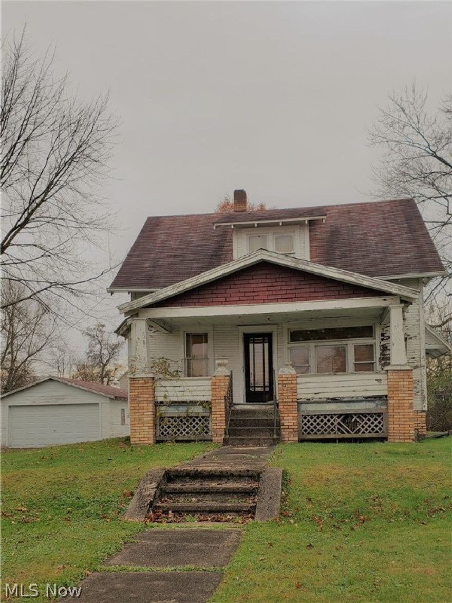 Opportunity awaits! Here is your next project!! Large city lot, nice location. Home with 2 car detached garage. All city utilities. Sold "AS IS".