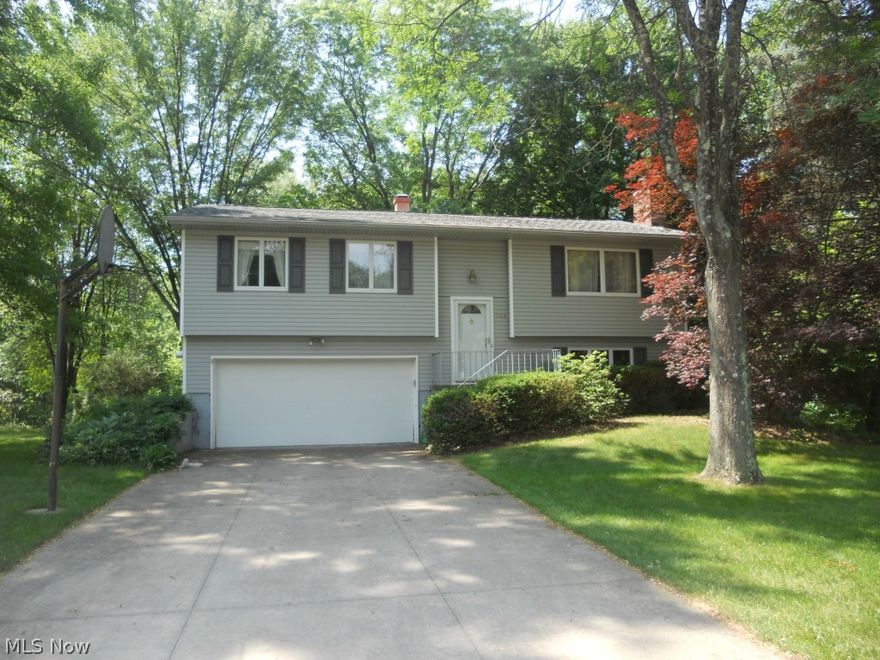 Welcome to this well maintained 3 bedroom 2 bath home.  Kitchen offers beautiful cherry cabinets and corian counters.  Family features a fireplace and attached rec room.  The finished walk out lower level leads to one of the 2 decks and backs up to a beautiful wood lot with a creek running behind property.  Must see home.