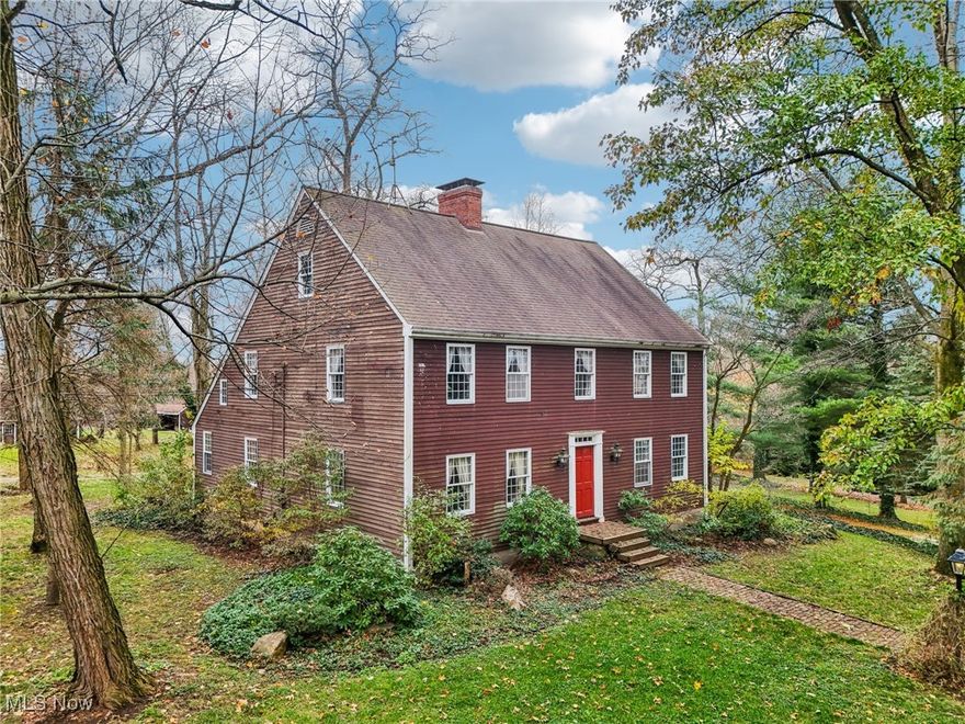 This charming home, inspired by the classic Salt Box Colonial design, sits on 7.57 private, wooded acres, blending timeless character with modern amenities. The property features a circular driveway for easy access. Free gas for added self-sufficiency. Other highlights include an oversized 3-car heated garage, a massive pole barn with incredible amenities, and beautifully landscaped grounds with flowering perennials, apple and chestnut trees, and Concord grapevines. The rear brick patio and deck provide a perfect retreat for outdoor living, while over 100 evergreen trees define the property lines and add privacy.

Inside, the home showcases superior construction with natural woodwork and an open floorplan that. Pella windows throughout fill the home with natural light. The main house offers 4 bedrooms and 2+ full baths, including a half bath on the first floor. The second floor features a spacious owner’s suite with an en-suite bath, two additional bedrooms, and a full bath with a dual vanity. The insulated third-floor space provides flexibility for various uses. A formal foyer with a coat closet leads to a 23x20 cherry eat-in kitchen with a woodburning/pellet stove, a 17x15 family room/den/dining area with built-in bookshelves, and a 23x15 living room with wood floors, a decorative gas fireplace, and French doors. The walk-out basement offers additional storage space or potential for finishing.

The property also includes a versatile pole barn completely rebuilt from the ground up in 2000 with over 1,700 square feet of bonus living space, featuring a kitchenette, pantry, and a 31x23 vaulted studio/loft with thick plank floors and a fireplace—ideal for meetings, entertaining, or creative projects. A full bath is also included in the pole barn for added convenience. With its unique blend of charm, quality construction, and exceptional features, this home is one-of-a-kind. Roof 2008 with 40 year shingle, updated HVAC,  Don’t miss out—schedule a showing today!