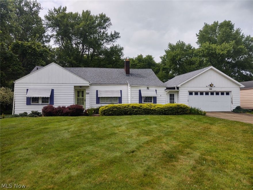 SPACIOUS BUNGALOW HOME:  This bungalow cape-cod home features three large bedrooms with two bedrooms being on the main floor.  Eat-in kitchen with appliances, spacious living room with built in shelving and fireplace that leads to a formal dining room.  One 1/2 baths, full basement with laundry room and shower.  Enclosed back patio where you can enjoy the peacefulness of the 3/4 acres of land.  Two car attached garage.  New flooring in kitchen and bath.