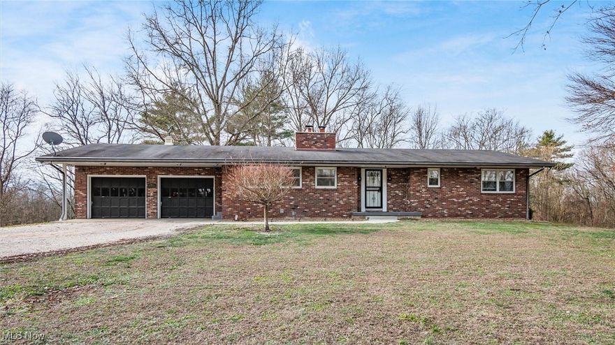 Welcome to peaceful country living just minutes from town! This 3-bedroom, 2-bath brick ranch sits on 7.81 scenic acres at the end of a quiet dead-end road, offering privacy, space, and endless possibilities. Inside, you’ll find 1,514 square feet of comfortable one-level living, featuring a welcoming foyer, spacious living room with a wood-burning fireplace, and a functional kitchen with breakfast bar and included appliances. All bedrooms are conveniently located on the main level, including a primary suite with his and hers closets. The full walk-out basement offers excellent storage or future finishing potential and includes the laundry area. Step outside to enjoy the outdoors from the deck, patio, or screened porch, all overlooking wooded views and open land.
Car enthusiasts, hobbyists, or those needing extra storage will appreciate the attached and detached garages with space for up to 4 vehicles. With public water, septic system, and a solid combination of brick and cedar construction, this home offers both durability and charm. A rare opportunity to own acreage, privacy, and a well-maintained ranch. Schedule your showing today!