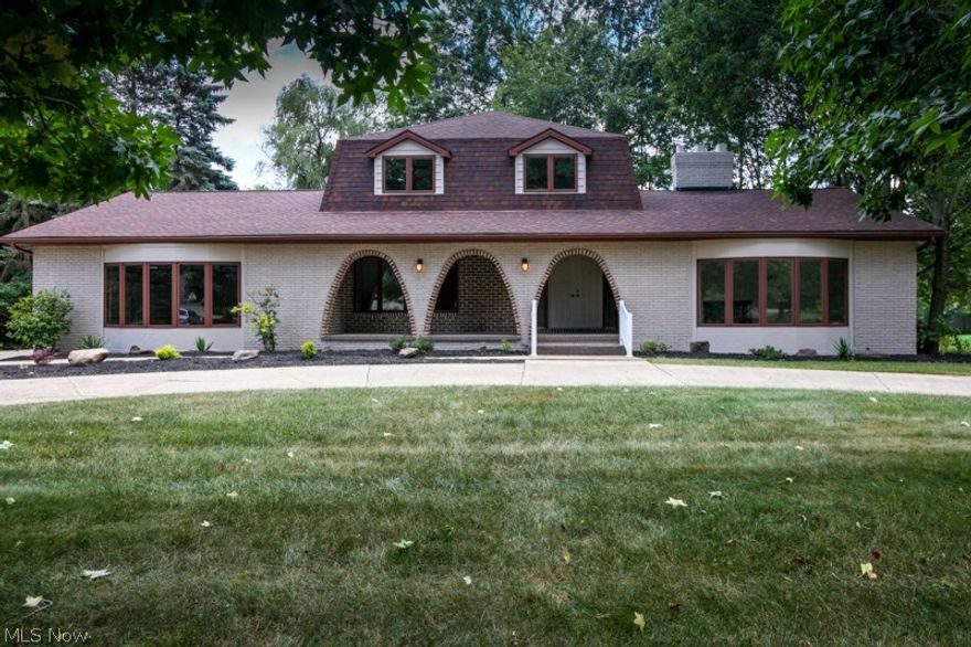 Mediterranean Style Design! The moment you walk into this home you'll enter into a spacious foyer with exposed staircase to second floor. Great room with cathedral beamed ceiling and large wood burning fireplace leading into a four seasons room with plenty of exterior view. Entertaining-size living room! Beautiful, formal dining room with gracious trim. Well groomed 2.5 bathrooms, first floor laundry room, master bedroom suite with private balcony. A huge 20' kitchen with center island and new stainless steel appliances. Wide lot with circular driveway and nice size finished garage. You must look at the  " NEW " improvements: high efficiency furnace, central air unit, hot water tank, floor coverings, painting, fixtures and more. Extra Nice-Extra clean and located in a neighborhood of high end value homes!