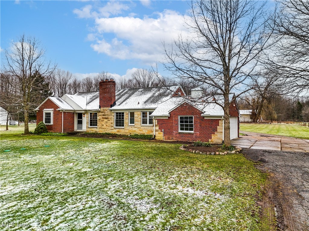 Nestled within the serene embrace of Orange Village, this remarkable 5 acre property at 4310 Brainard Road offers an unparalleled opportunity to own a piece of natural paradise. Spread across nearly 5 acres of beautifully wooded land, this expansive parcel provides the ultimate in privacy & tranquility. Imagine waking up to the gentle rustle of leaves and the soft glow of sunlight filtering through mature trees, with your own private pond shimmering in the distance. The property's proximity to a conservation area further enhances its natural appeal, creating a secluded haven where wildlife thrives and the beauty of the outdoors is right at your doorstep. The centerpiece of this magnificent setting is a stunning, recently renovated all-brick Ranch home. With its thoughtful updates, including refinished hardwood floors, updated bathrooms, and newer windows throughout, this residence is move-in ready. The inviting first floor features 3 bedrooms and 1.5 baths, while the finished second floor adds a versatile bedroom and half bath, providing ample space for any family. Boasting 2,165 sq ft, this home also includes a den, a cozy fireplace, a full basement (partially finished with its own fireplace), and a 2-car garage. Recent upgrades like a new roof (approximately 5 years old), a central boiler, a newly updated kitchen with newer stainless steel appliances, a new garage door, and a new septic system ensure easy maintenance and modern comfort. City water further enhances the property's appeal. Whether you envision this beautifully maintained home as your personal sanctuary or seek the perfect canvas to build your dream estate in the highly coveted Orange School District, the possibilities are endless. This unique offering presents a rare chance to own a substantial, private, and naturally exquisite parcel of land. Don't miss this exceptional opportunity to explore the vast potential of this extraordinary property today!