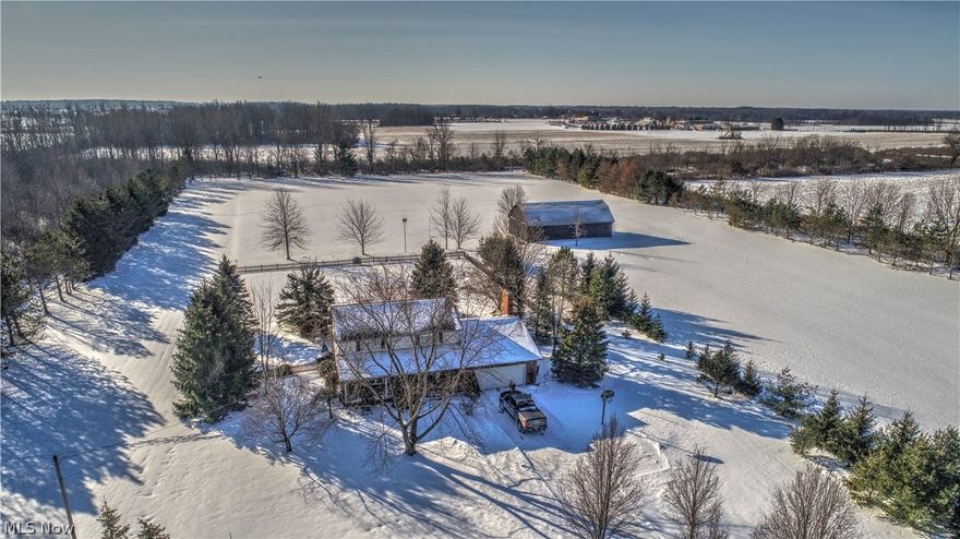 Impressive colonial is situated on 9.81 acres in Henrietta Township, Firelands Schools. This 1-owner, custom-built home has been well maintained. Long driveway lined with a lush canopy of Bradford Pear trees. Enjoy the country view from the front porch or back porch. Back porch overlooks an inviting in-ground pool. Cook to your hearts delight in the country kitchen which features custom cabinetry and a double-oven. Large family room with crown molding, oak paneling, and a cozy wood-burning fireplace. Bright and airy formal living room and dining room features large bay/bow windows. Pella windows throughout the entire house. Master bedroom with a walk-in closet, separate vanity area, and en suite bathroom. Finished basement with a large adjoining utility room. Outside access through Bilco doors. Large barn with electricity, running water, and loft areas. Barn could easily accommodate 7 stalls for horses or other livestock. Newer carpet upstairs. Ceilings and walls recently repainted. Newer vinyl flooring in kitchen, foyer, and half-bathroom. Arrange your private tour of this must-see property.