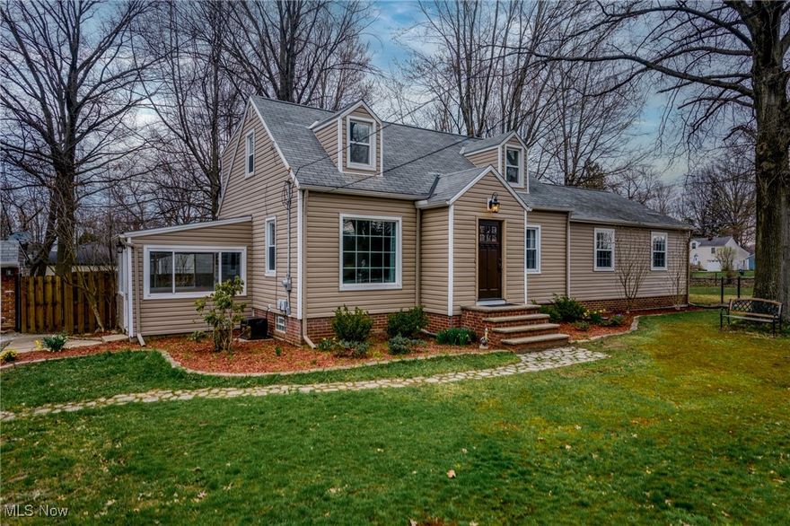 Welcome to this charming 4-bedroom, 2-bath Cape Cod home in the highly desirable town of Willoughby Hills. Step inside to discover original hardwood floors that seamlessly flow from the sun-filled living room into the formal dining room. The updated kitchen features sleek laminate countertops, a matching backsplash, and included appliances, with a spacious pantry for ample storage. The main level has been refreshed with new luxury vinyl plank flooring and fresh paint, adding a modern touch. Three generous first-floor bedrooms provide flexibility and comfort, complemented by a full bath with a luxurious soaking tub. Upstairs, the expansive master suite offers a peaceful retreat with its own private bath. The partially finished basement, complete with a rec room and bar, is perfect for entertaining. Outside, a spacious deck overlooks a picturesque, tree-lined lot spanning nearly 1.5 acres. A/C and furnace fully replaced in 2020. An oversized two-car garage provides additional storage, making this home as practical as it is inviting.