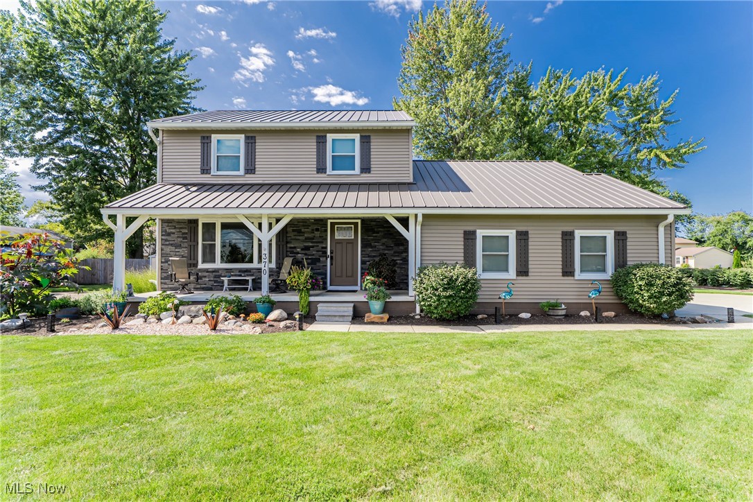 Welcome to this beautifully updated colonial sitting proudly on a corner lot, where every detail has already been done for you! Truly move-in ready, this home combines modern upgrades with inviting spaces, both inside and out. The curb appeal shines with brand-new siding, a striking stone composite facade, and a brand-new metal roof on both the home and backyard storage shed. The new concrete driveway (2020) leads to an insulated garage door, while the covered front porch offers the perfect spot to relax. Step inside to find new LVP flooring throughout, a spacious living room, a formal dining room, and a cozy family room featuring a whitewashed brick electric fireplace. Sliding doors open to the private backyard oasis, complete with a stamped patio (2022)—ideal for entertaining. The kitchen is a chef’s delight with granite countertops, a breakfast bar, and updated appliances. Upstairs, you’ll find three comfortable bedrooms, while the finished basement provides extra living space, laundry, and a backup sump pump for peace of mind. Major mechanicals have all been updated within the past 5 years, including the furnace, A/C, and hot water tank. This home blends convenience and quality—located on a busier road, yet the driveway entrance is tucked away on a quiet neighborhood street. With thoughtful updates like the shed (2021), stamped patio, and countless interior improvements, there’s nothing left to do but move in and enjoy.