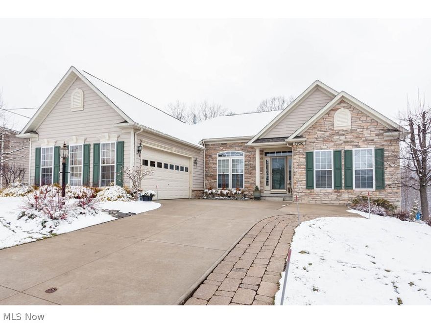 Stunning Ranch Cluster Home in The Woods of Glencairn with finished walkout lower level and backs up to woods.Several recent renovations and updates!  3 bedrooms with 2.5 baths on the main level, with a 4th bedroom and full bath in the lower level.  Open floor plan with high ceilings, tons of natural sunlight and new hardwood floors throughout the majority of the 1st floor.  Gourmet kitchen opens to great room with stone fireplace. Kitchen has granite counter tops, breakfast bar, gas range and double ovens.  Master suite features wooded views, master bath with oversized jacuzzi tub, and 14 x 12 walk-in closet/dressing room.  Walkout lower level features spacious family room.media room, office/exercise room/yoga studio, craft room, and 4th bedroom with full bath.  Enjoy outdoor entertaining on the maintenance free deck and patio.  Oversized, side loading, 2.5 car garage with attached mud room.  1st floor laundry. Revere schools.  Great proximity to both downtown Cleveland and downtown A