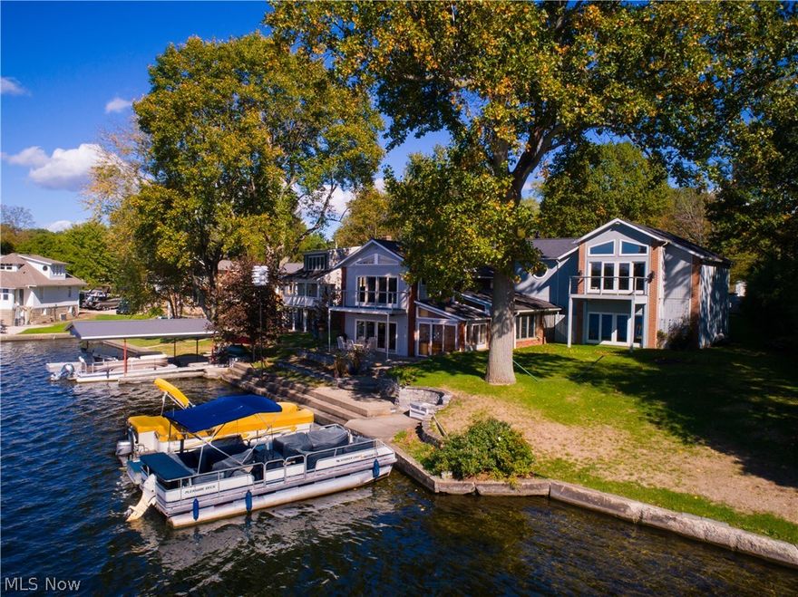 Incredible water views every day of the year from almost every room including attached garage* Fabulous 125' lake front (.43 ac) on E. Reservoir, totally rebuilt 1990 from masonry walls in (including footers & studs)* 2 story w/3 BR, 3.5 BA, 3588SF w/30x23 attached heated garage (18x8 garage door) & 3 car detached heated garage w/16x24 heated & fully equipped workshop & full bath (actually 4.5ba)* Vaulted entry* Office* Family room w/WBFP (gas starter)* Eat in applianced kitchen w/breakfast bar, corian & 2 pantries (one walk in)* 1st flr laundry room w/sink & cabinet* 1st flr full bath* 4 season vaulted sun room w/skylight, wet bar & access to patio, family room, full bath & garage* 2nd flr...Huge vaulted great room w/wood floor, fans, built ins & double slider to balcony w/cable railing; Vaulted master w/walk in, double slider to balcony (cable railing) & vaulted master bath w/walk in steam shower (9 shower heads w/mega pressure), double vanity & jetted tub-all with lake views; 2 gues
