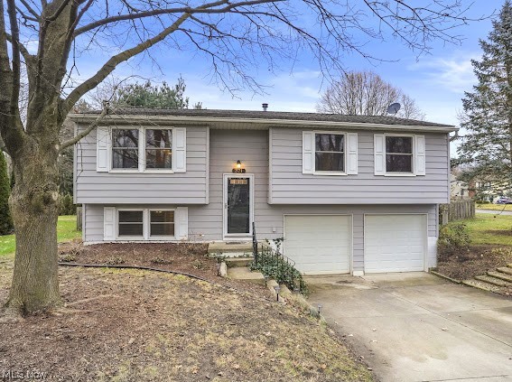 371 Michaels Drive, Kent --- this 4 bed/2 full bath property turn-key property is move-in ready! Inviting 2-story flyer. Open floor-plan with a spacious main living area. Completely updated (2019) bright white eat-in kitchen, subway tile backsplash, tile flooring, peninsula & stainless steel appliances. Dining area leading out to the back deck and fenced in backyard. Three bedrooms are down the hall next to the newly updated (2023) bathroom including new vanity, tile flooring + tub/shower surround. Lower level is accessible to the 2-car attached garage & another bedroom w/ a walk-in closet or even an additional entertainment area + a full bathroom. Laundry area with washer and dryer are included + a wash tub sink. Other updates include carpet (2018), HWT (2018), A/C unit (2019), stainless steel appliances (2020). Paved Driveway, Storage Shed, beautiful high-end low maintenance landscapes including natural pollinator flowers, grasses, and perennials in the flower beds. There are well established raspberry bushes, strawberry plants and lavender + chives that come back year after year! Kent Local Schools. Desirable Location. Tucked away in a neighborhood, yet in close proximity to all amenities such as Downtown Kent, KSU, NeoMed, Restaurants, Shopping and more! Your opportunity to OWN this immaculate property is NOW!