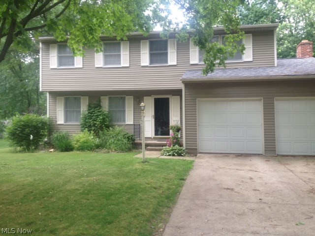 Don't miss this Move in ready 4 BR Colonial on quiet Munroe Falls Street yet close to everything. Recently installed hard wood flooring throughout the first floor. The kitchen with ample cabinets, pantry and counter space opens to the family room with fireplace and the charming Sun Room to enjoy the sunshine and beautiful outdoors. Fenced yard, too. Lower level Rec room provides additional living space. Close to schools, shopping and Munroe Falls Metro Park with tennis, swimming, picnic area, walking and hiking trails.