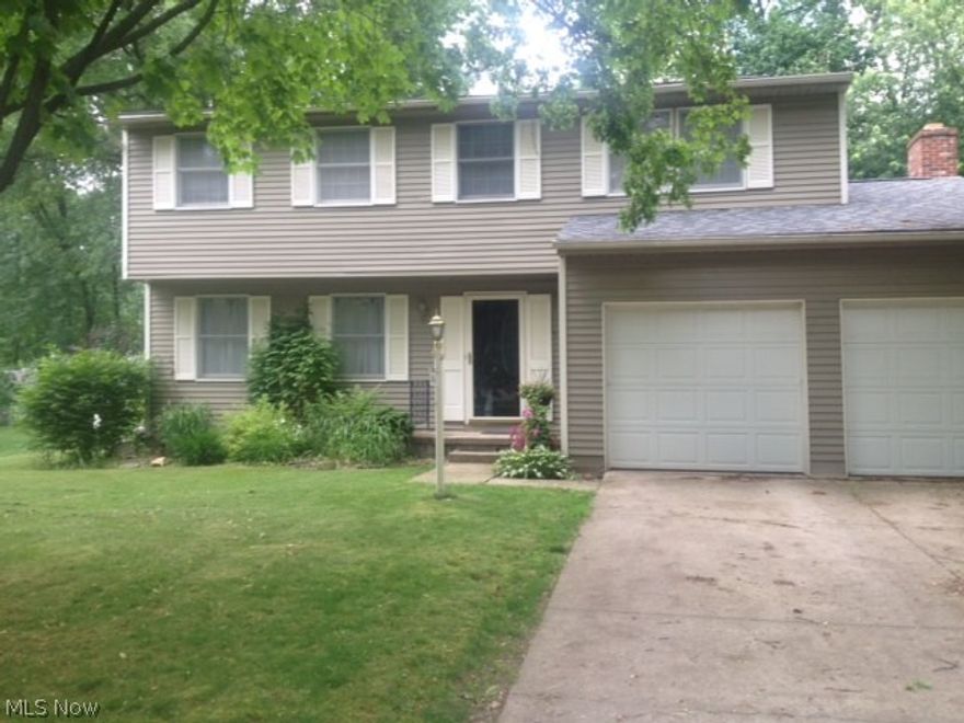Don't miss this Move in ready 4 BR Colonial on quiet Munroe Falls Street yet close to everything. Recently installed hard wood flooring throughout the first floor. The kitchen with ample cabinets, pantry and counter space opens to the family room with fireplace and the charming Sun Room to enjoy the sunshine and beautiful outdoors.  Fenced yard, too.  Lower level Rec room provides additional living space.  Close to schools, shopping and Munroe Falls Metro Park with tennis, swimming, picnic area, walking and hiking trails.