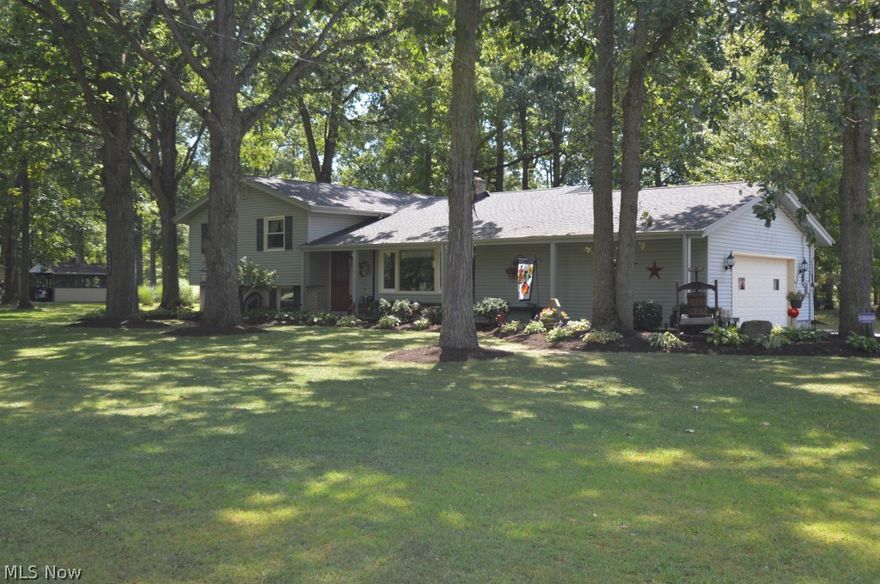 Remarkable home in Western Reserve school district situated on a beautiful treed acre just outside of Canfield. This home is over 2400 square feet and offers 4 bedrooms with hardwood flooring on the second level along with 2 full baths. The master bedroom features large walk in closet. On the main living floor you will find an open floor plan that features a large living room, dinging room, galley kitchen that features oak cabinets and updated counter tops, back splash and sink. Just off the kitchen you will find a large eat in kitchen with wood burning fireplace with new liner and bay window. On the lower level you will find a fifth bedroom that was used as an in-law suite and a large family room  and laundry room that offers plenty of storage and access to the back enclosed porch. Enjoy spring and summer from your screened in back porch that is great for entertaining and enjoying the warmer months that Ohio has to offer. New furnace and AC in 2013 and new dishwasher in November 2015.