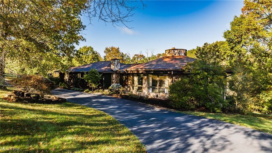 First time on the Market....Custom built cedar and stone home, designed by architect Henry D Norris. Minutes from the city, this unique home is situated on 23+/- acres. 4 Bedrooms, 3 1/2 baths, with over 3500 sqft of living space. You'll fall in love with the spacious 8 sided 18x33 Living room and Dining room, with a beamed wood cathedral ceiling, floor to ceiling windows and an impressive stone wood burning fireplace. Around the corner is an 19x12 eat-in kitchen with hardwood floors, granite counters and beautiful wood cabinets, adjoining a fireside 18x16 family room where you'll enjoy a cup of hot cocoa. Patio doors lead you out the back to a screened in deck, with access to another deck with views of the pool, tennis court and woods beyond. All the rooms are more than ample in size. You'll find 4 bedrooms and 2 1/2 baths on this main level. The 19x16 Primary suite has a spacious walk-in closet, full bath and access to the back deck. Plenty of natural light throughout the home! In the lower level, the 31x19 rec-room has an additional wood burning fireplace, and walks out to the back patio.  The 16x10 laundry room and full bath is located here, with access to the 16x22 2 car garage and workshop. You'll enjoy the warm weather in your beautiful back yard with your own heated in-ground pool and full sized lighted tennis court. Want more? How about horses!  You can have them here with the 8 stall barn! It has heat, lights, a hayloft, feed room, tack room, wash bay, rubber flooring, skylights, internet & phone connections, auto-waterers and fly spray system. 60/30 RV charging. The acreage has an exercise arena, fenced pastures and riding trails. What else can you want? It's PARADISE on earth! 
All room measurements approximate.