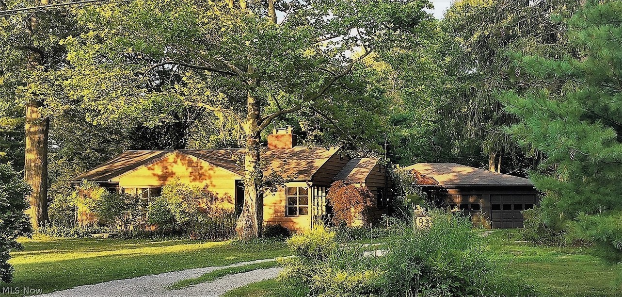A one-of-a-kind home in a serene parklike setting with great sunset views, open floor plan with wood-burning fireplace, beautiful large screened porch overlooking the rear garden, attached 2-car garage with workshop space, a separate potting shed with sink and storage.