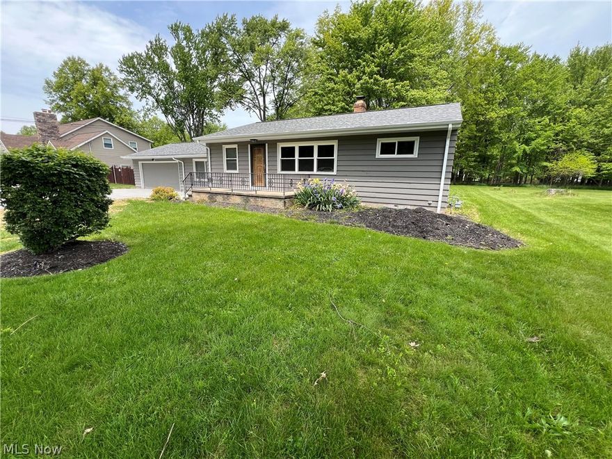 Nestled in beautiful Westlake, this beautifully maintained 3-bedroom, 2 full bath ranch offers the perfect blend of comfort, style, and functionality on nearly a half-acre lot backing to peaceful wooded green space. From the moment you arrive, you’ll appreciate the brand-new driveway with additional parking, charming large front porch, and inviting curb appeal. Inside, gorgeous hardwood floors flow throughout the front family room, formal dining area, and the entire main level, including all three bedrooms. The updated kitchen is sure to impress with granite countertops, newer stainless-steel appliances, newer cabinetry, and abundant counter space perfect for cooking and entertaining. Enjoy additional living flexibility with a spacious bonus room/breezeway that can serve as a second family room, home office, or entertaining area. The updated full bathroom on the main level features granite countertops and a beautifully tiled ceramic shower. All bedrooms include newer fixtures and ceiling fans for added comfort and style. Additional updates include a newer roof and an attached two-car garage. The partially finished basement expands your living space even further with a second full bathroom, creating the perfect setup for entertaining, recreation, or relaxing. Step outside to the expansive concrete backyard patio overlooking the serene, wooded backdrop — an ideal setting for gatherings, relaxing evenings, or outdoor entertaining. This move-in ready ranch combines modern updates, timeless charm, and an exceptional setting in one of Westlake’s most desirable locations.