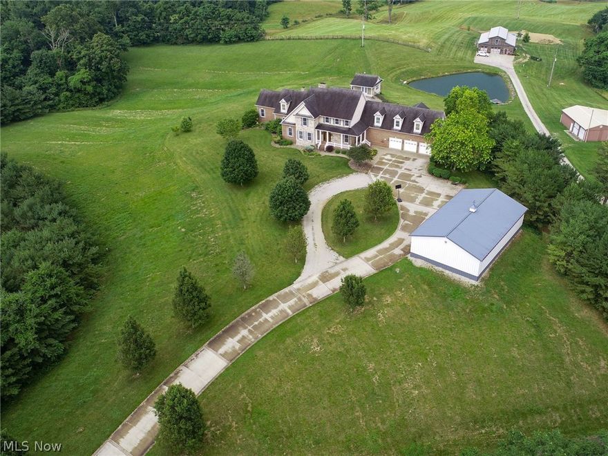 Brick 2 story with 6 bedrooms, 8 baths, and 7.62 acres with country views in every direction! Inground pool and poolhouse. The paved drive approaches a 3-car attached garage with a large private office above featuring a built-in desk. An additional oversized 2 car garage/workshop is insulated and has water and electricity. Impressive fully-applianced at-in kitchen with hickory cabinets, solid surface countertops, high-end appliances, breakfast bar, a walk-in pantry, and a fireplace. 1st-floor great room with wood-burning stone fireplace and built-in hickory entertainment center. A large formal dining room, the recreation room is located right off the dining room and is complete with a wet bar and half bath. The beautiful year-round sunroom leads onto the covered porch in the rear. Oversized 1st-floor master suite includes a tile shower bath & fireplace.  The walkout basement includes a bar area and an amazing great room, 2 full baths an exercise room, and even a built-in walk-in safe. Outback is a pond with a dock. New Lennox HVAC installed in 2020, on-demand water heater 2020, all fireplaces services in 2020, pool liner replaced in 2019, all toilets new in 2021, This home has so much to offer, make an appointment to view this beauty.