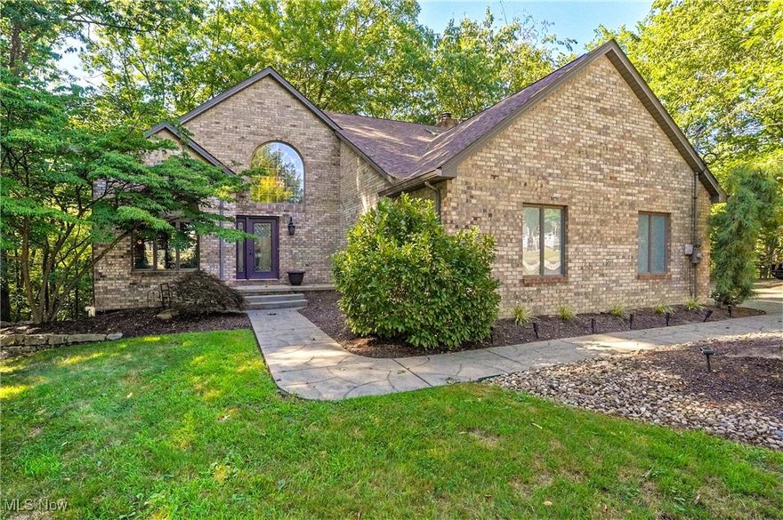 The one you’ve been waiting for—where comfort and character collide and nature wraps it all in peace.
This 3-bedroom, possible 4 bedroom and 4-bath stunner (2 full + 2 half baths) is tucked on just over an acre of wooded privacy in the heart of Austintown. From the dramatic two-story foyer to the handcrafted wood details, this home blends timeless design with modern warmth.

The family room centers around a show-stopping fireplace, flanked by arched windows that frame the view of the trees beyond. With slate tile, built-in shelving, and a touch of artistic flair, it’s the kind of space that makes you want to sit, sip, and stay awhile.

The kitchen is equal parts cozy and functional, featuring granite countertops, a deep sink, updated lighting, and an abundance of cabinetry—perfect for hosting or whipping up your next family favorite. Enjoy the open flow into the eat-in dining area and family room, all tied together with warm wood flooring and natural light.

Upstairs, the primary suite is your personal sanctuary with a spa-inspired ensuite: granite counters, tiled floors, updated sinks, fixtures, and more. And when it’s time to entertain or recharge? Head to the expansive deck or the full walk-out lower level—ideal for game nights, movie marathons, or simply soaking in the hot tub while nature does its thing.
And the updates? Nearly everything’s been touched:

New roof + downspouts (2024)

New central air (2022), furnace (2021), and water heater (2021)

Updated laundry room, stamped concrete patio, skylights, deck paint, shed pad—and so much more.


Welcome to a home that’s more than just well-kept—it’s genuinely well-loved.