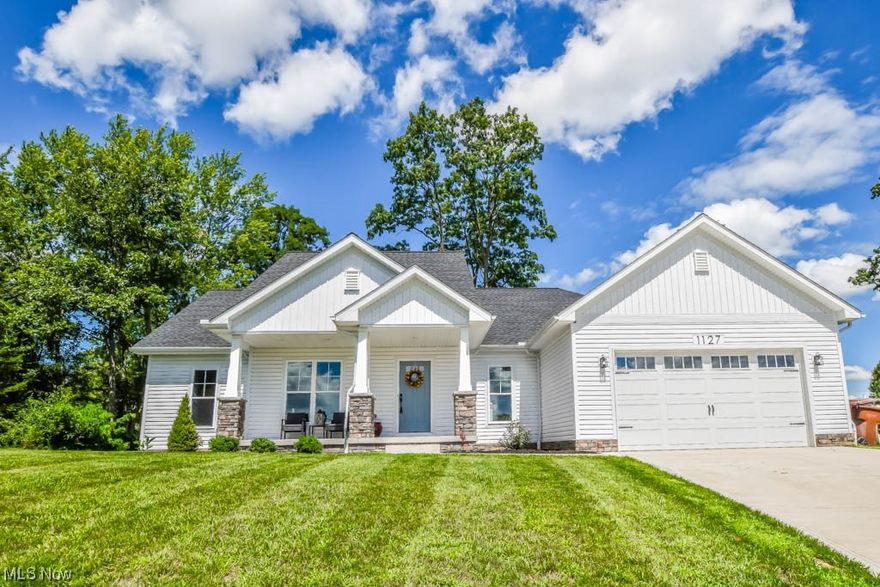 Why build when you can own this like-new 3 bedroom, 2 bath ranch situated on a spacious lot at the end of a quiet cul de sac! The warm and welcoming exterior boasts  clean, neutral colors with stone covered pillars accenting the covered front porch. Step inside to the vaulted great room featuring a floor-to-ceiling stone fireplace and open view into the kitchen equipped with soft close hardware, a subway tile backsplash, quartz countertops, and a center island The dining area provides access to the covered back porch and concrete patio in the backyard. Thoughtfully designed, the split bedroom layout provides privacy to the master suite featuring a sliding barn door entry to the spa bath featuring dual sinks, a walk-in shower, a freestanding tub, a separate commode, and a spacious walk-in closet with built-in organizers. On the other side of the house, you'll find two bedrooms, a full bath with hexagonal tile shower surround, and a hallway with linen closets. As you enter from the 2-car attached garage, the mudroom adds practical elements like a bench, storage cubbies, and coat hooks with a shiplap accent wall. Other amenities include a first-floor laundry room and a full basement that could be finished for more living space. Call to see this beautiful home today!