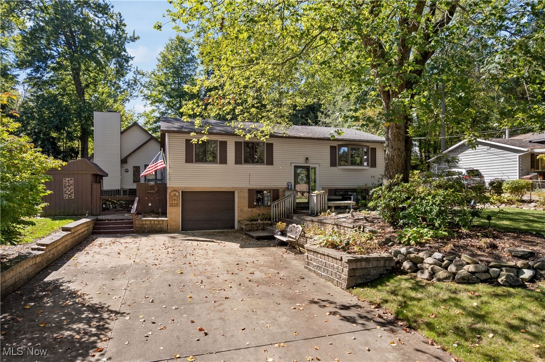 Lovingly cared for by the same family for nearly 50 years, this charming 3-bedroom, 1-bath bi-level home offers warmth, comfort, and incredible versatility. Tucked away in the Melody Village neighborhood and set on a fully fenced 0.28-acre lot, it provides the perfect blend of privacy and convenience. Step inside to find a bright living room with large windows and neutral tones that flow into the spacious dining room, filled with natural light and featuring sliding glass doors to the backyard. The kitchen comes fully applianced, with a breakfast bar and plenty of cabinetry, making meal prep a breeze. The lower level adds incredible flexibility with a partially finished family room, complete with a decorative fireplace, as well as an unfinished storage area. A sink and toilet are already in place, offering potential for a second full bath. The true gem of this property is its unique, private backyard oasis. Designed for gatherings or quiet retreats, you’ll enjoy a built-in firepit, a charming pergola, and multiple seating areas on the expansive deck and patio. Mature trees add shade and privacy, while the fully fenced yard is perfect for pets or play. In addition to the standard storage shed, the highlight of the property is the impressive 45x23 outbuilding. With a finished showroom featuring stonework and vaulted wood ceilings plus a massive workshop and office, this space offers endless possibilities—whether as an entertainment lounge, home office, hobby space, or dream workshop. A rare opportunity—this home’s quiet location and the versatility of its outdoor spaces make it a one-of-a-kind find. Bring your vision and make it your own! Water softener tank replaced in 2024 and AC unit replaced in 2022.